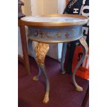 A French painted and gilded lamp table with circular plate glass top and raised on three cabriole