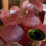 A pair of cranberry glass vases with fla