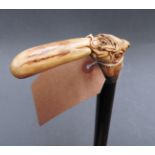 An ebonised stick, having horn handle