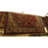 A large Persian tabriz style carpet, the