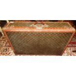 A large vintage Louis Vuitton suitcase