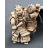 An early 19th Century carved ivory figure of Samurai warrior and child