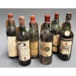 A collection of six vintage bottles of red wine, of various conditions,