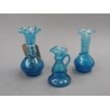 A set of three Murano style blue glass posy vases having spiral twist stems,