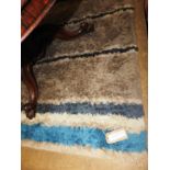 A contemporary Designer's Guild style thick piled rug,