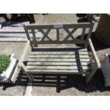 A grey painted garden bench of small proportions