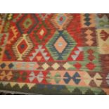 A Kelim rug with ten central medallions on multi coloured ground