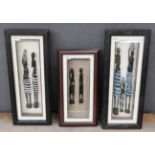 A set of three box framed carved African figures