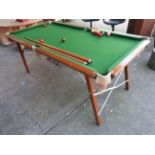 An oak snooker table on folding legs