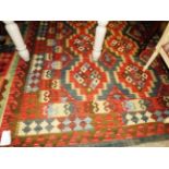 A Kelim rug with eight central diamonds on multi coloured gorund