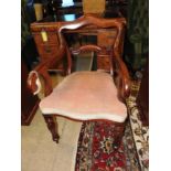 A Victorian mahogany armchair with stuffover seat upholstered in beige velour and raised on turned