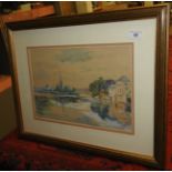 A framed and glazed watercolour of an English town beside a river with a church spire beyond,
