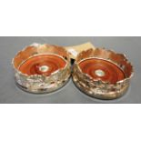 A pair of silver plated grapevine form coasters