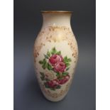 A white porcelain vase with gold rim and floral decoration