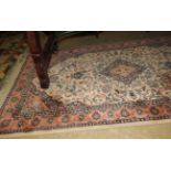 A Persian style rug with central medallion on beige field
