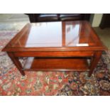 A mahogany two tiered table with single drawer