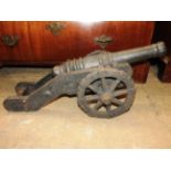 A pair of early 20th century cast iron cannons with crest detailing (2)