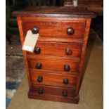 A pair of mahogany style with five drawers with bun handles