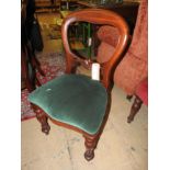 A set of mahogany spoon back dining chairs with green velour pad seats