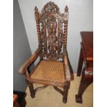 An ornately carved throne chair with cane seat over ropetwist supports (af)