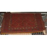 An Afghan red geometric design rug