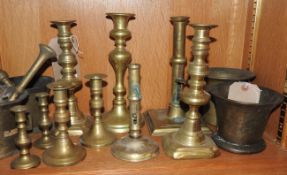 A quantity of brass candlesticks,