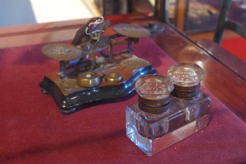 A pair of late 19th century brass and walnut postal scales together with a twin inkwell.