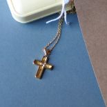 An 18ct gold cross set central diamond together with an 18ct gold chain