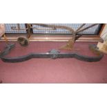 A 19th century French cast iron fire kerb of shaped outline with female mask centre and Fleurs De