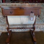 A Victorian rosewood work table fitted single drawer and with damask upholstered well beneath
