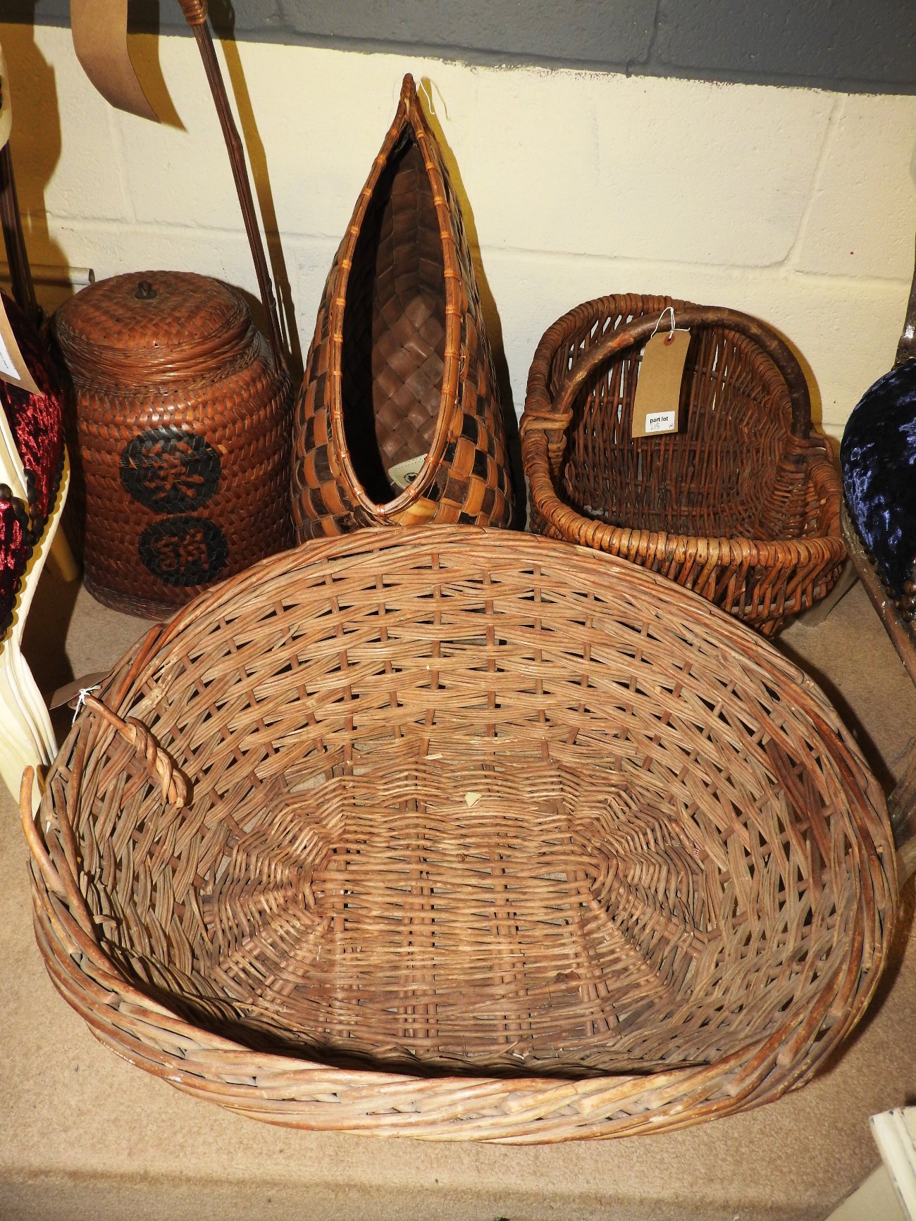 A collection of four wicker baskets to i
