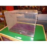 A perspex display case with rouge velour