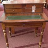 A mahogany desk with upstand above toole