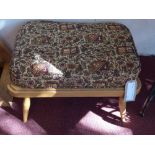 A retro Ercol footstool with tapestry up