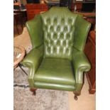 A pair of buttoned back green leather wi