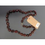 A Cherry amber necklace with yellow meta