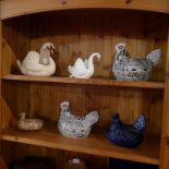 A collection of pottery hens and swan figures