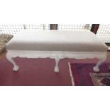 A French style white painted window seat upholstered in beige linen and raised on ball and claw
