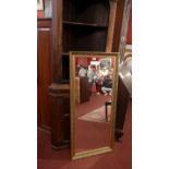 A wall mirror with rectangular plate and gilt frame