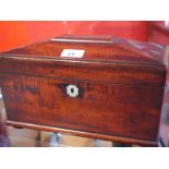 A Regency mahogany sarcophagus form tea caddy with fitted interior and blue glass mixing bowl