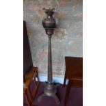 A 19th century brass floor standing oil lamp on oak supports