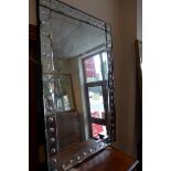 A vintage style wall mirror with rectangular bevelled plate and bubble border