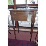 A Regency mahogany side table of small proportions fitted two drawers and raised on ring turned