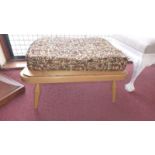 A retro Ercol footstool with tapestry upholstered cushion