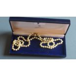 A Mikimoto pearl necklace with gold clasps 84cm long with box