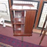 An Edwardian inlaid mahogany two tier revolving bookcase raised on swivel supports
