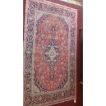A fine central Persian Kashan rug 220cm x 125cm central floral medallion with repeating spandrels