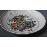A Chinese Doucai palette porcelain dish decorated with a hand painted still life depicting vases of