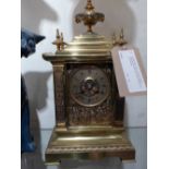 A 1920's brass mantle clock with detailed Chinoiserie decoration with figural scenes to the front
