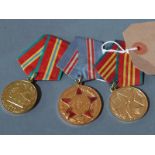 A collection of three Russian medals on silk ribbons